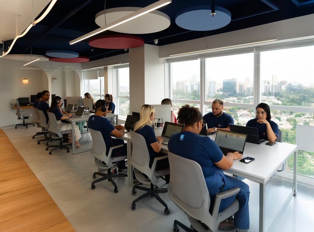 Equipe em atendimento nas estações de trabalho do escritório de Alphaville.